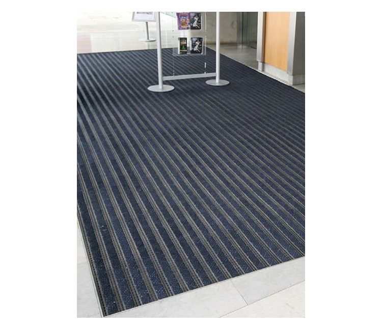 Premium Track interlocking entrance matting tiles with blue nylon carpet inserts fitted in a recessed mat well in a commercial lobby